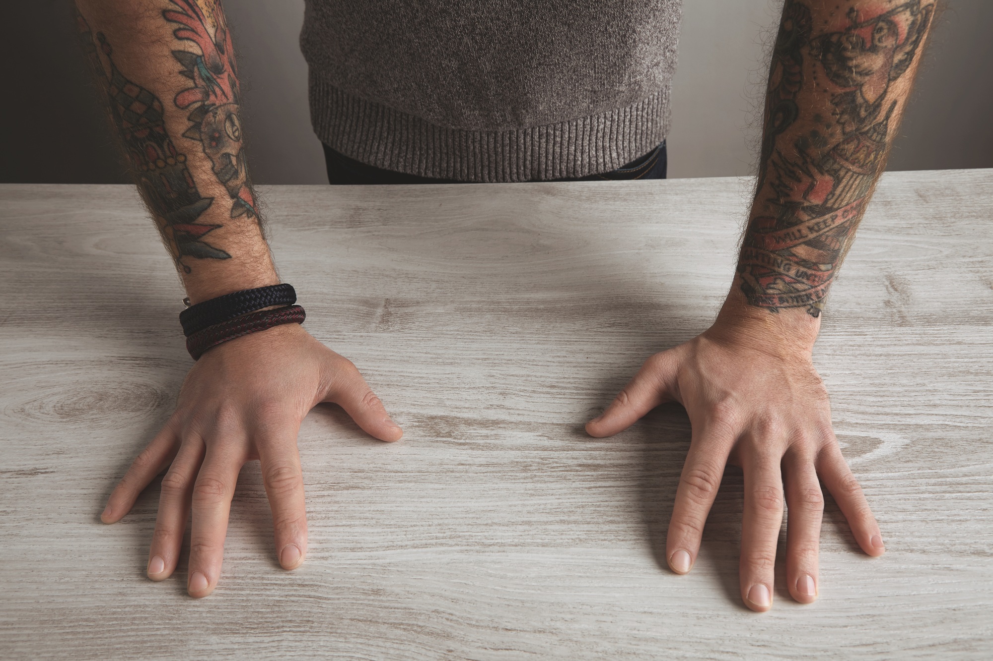 close unrecognizable brutal man tattooed hands isolated